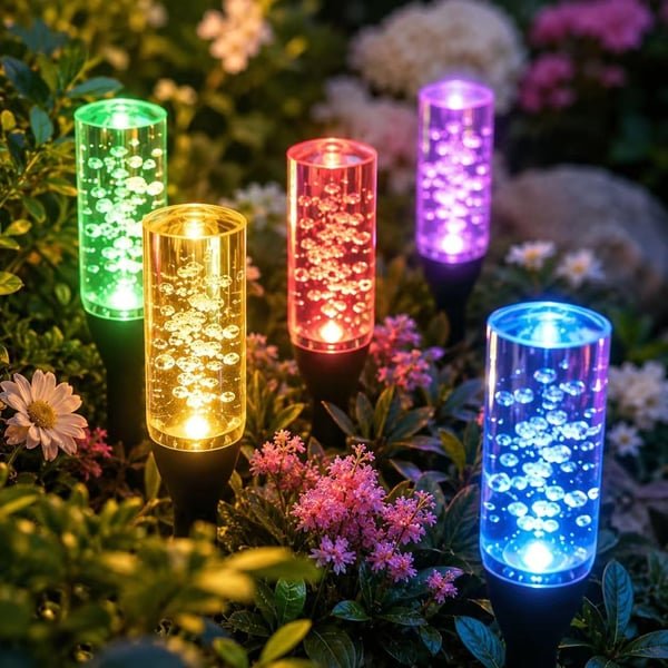 Close-up of colorful bubble-effect solar light heads among garden flowers